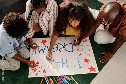 Canvas-taulu Parents and their two kids drawing I have a dream placard together