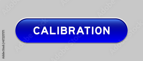 Blue color capsule shape button with word calibration on gray background