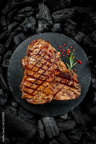 Bild auf Leinwand Beef T-bone steaks on BBQ grill coal