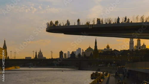 Time lapse, Soaring bridge with people above Moscow river in the park, view at Kremlin, Russia