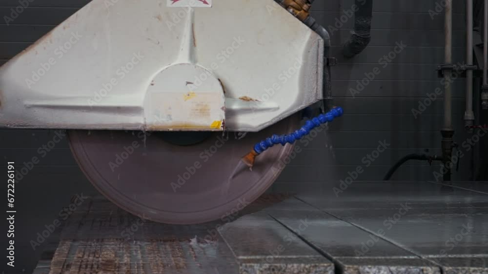 Modern cutting equipment is used for the splitting of the granite stone. An automated cutting machine is dividing the granite stone into pieces. Cutting the granite stone at the production factory. Modern cutting equipment is used for the splitting of the granite stone. An automated cutting machine is dividing the granite stone into pieces. Cutting the granite stone at the production factory.