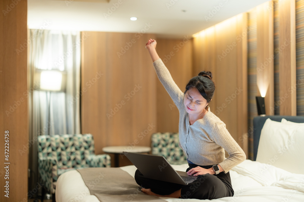 Woman feel tired for using laptop computer on bed in the evening Woman feel tired for using laptop computer on bed in the evening