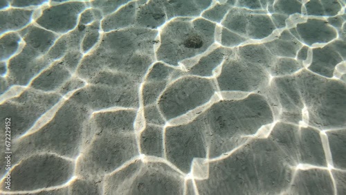 The sun's glare is reflected in sandy seabed, Red Sea