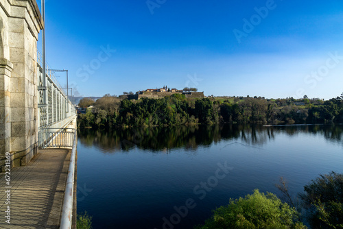 View of the Valença de Minho fortress reflecting in the river and the International Iron Bridge. Portugal. photo