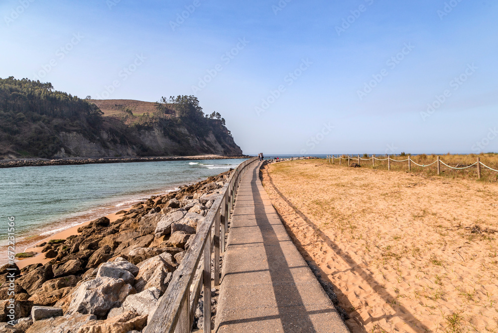 Wooden promenade next to the Villaviciosa estuary and Rodiles beach. Asturias, Spain.