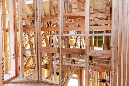 Construction new home unfinished framing beams wooden house in construction area