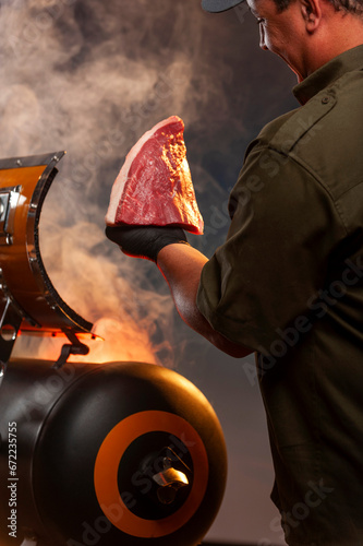 Barbecue master. Middle aged hispanic man for barbecue. Roasting, grilling and smoking food. Man hold rump cap barbecue. Smoking meat outdoors. Barbecue and grill.