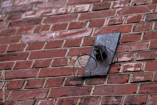 rusty wall construction fixing screw on red brick wall background