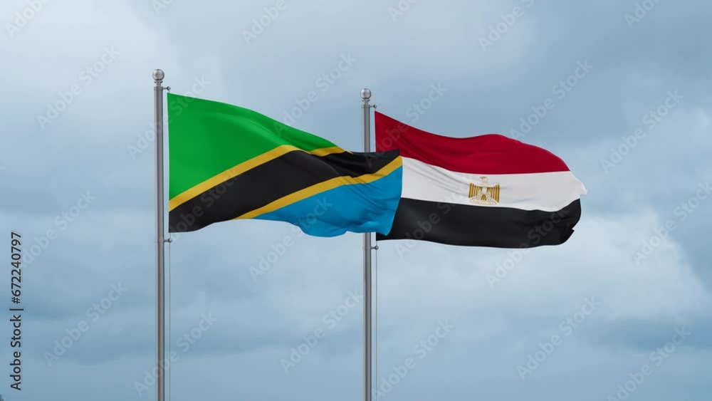 Egypt flag and Tanzania flag waving together on cloudy sky, endless seamless loop, two country relations concept Egypt flag and Tanzania flag waving together on cloudy sky, endless seamless loop, two country relations concept
