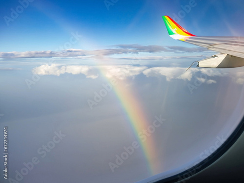 a view from a window aeroplane with a ray of light and rainbow lights
