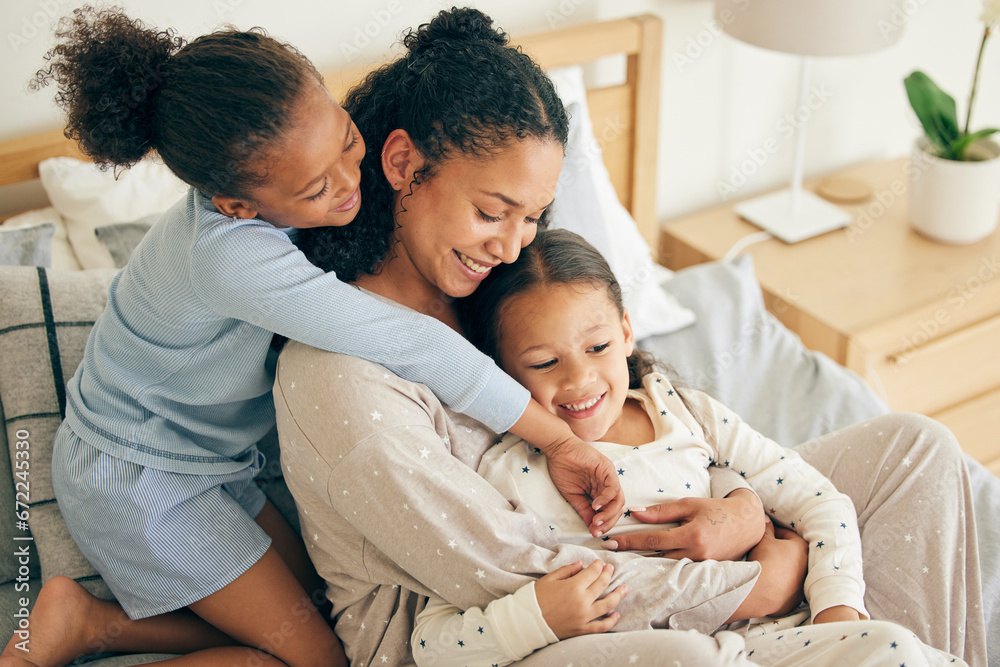 Mother, home and children hug or happy with parent together in the morning laughing in a bedroom on a bed. Funny, bonding and mom enjoy quality time with kids or girls with happiness and love
