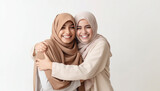 Young Islam girlfriends embrace and hugging each other wearing hijab. Isolated on white background. women in hijab hugging and smiling. Eid mubarak concept. Happy friends and Muslim