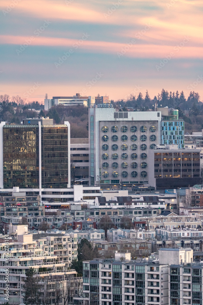 Colorful soft warm light over an urban cityscape with apartment buildings and tall high rises - Vancouver British Columbia