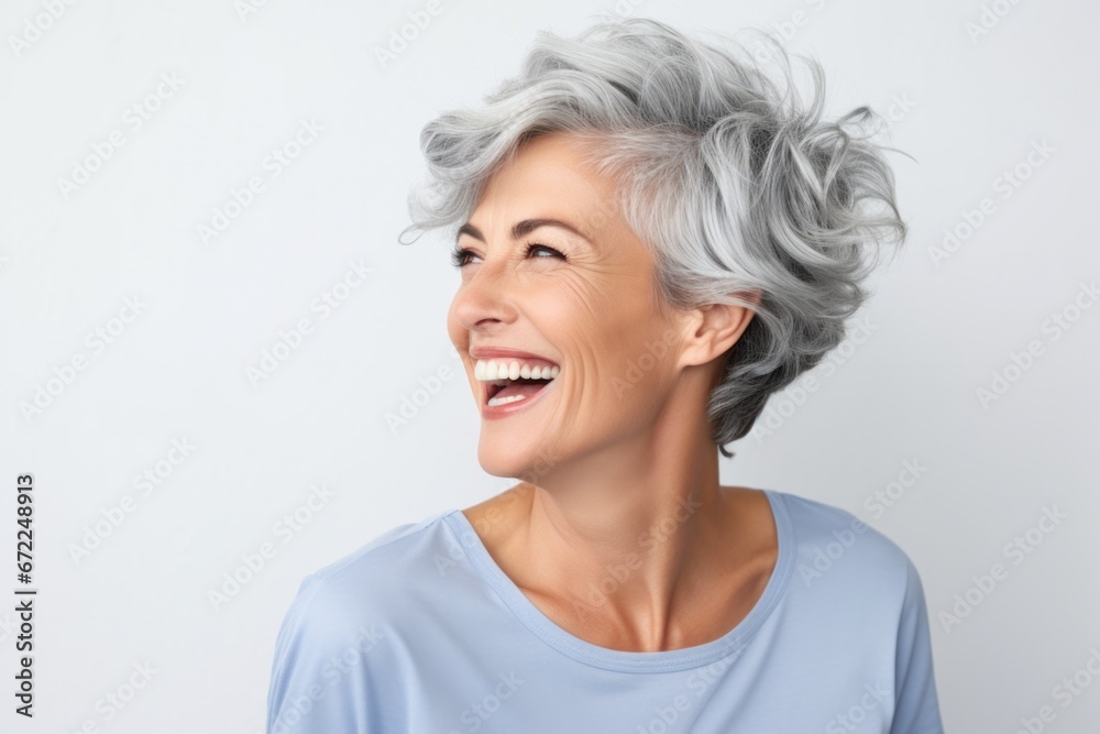 Smart stylish older woman with gray hair in a bright studio setting with room for text, looking aside Smart stylish older woman with gray hair in a bright studio setting with room for text, looking aside