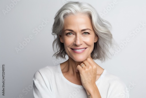 Portrait of a happy mature woman looking at camera over white background photo