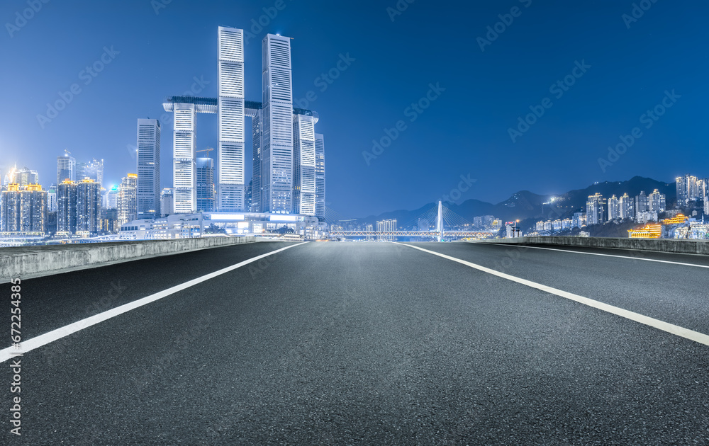 Asphalt road and city skyline night view in Chongqing