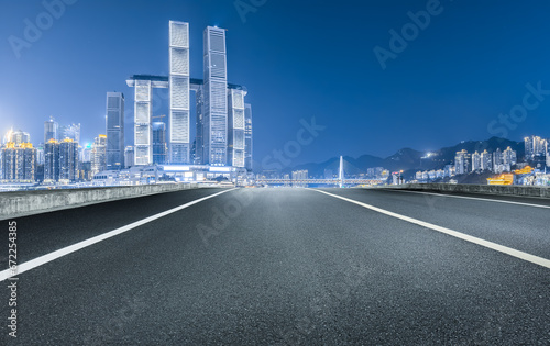 Asphalt road and city skyline night view in Chongqing