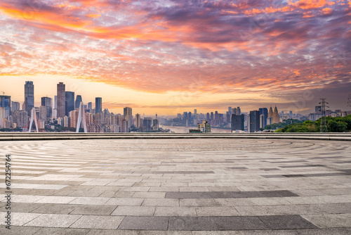 Square floor and city buildings skyline in Chongqing at sunset photo