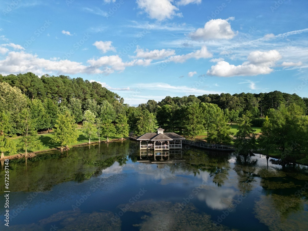 Aerial view of a lake in a forested landscape in Florence, Alabama