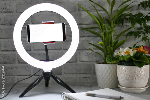 Desk ring light with blank phone screen - Concept mock up for blogger influencer online teaching photo