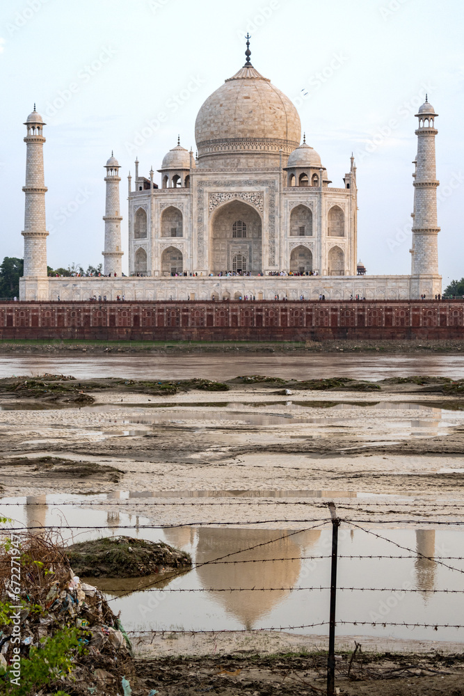Fototapeta premium The imposing Taj Mahal in Agra, India, with its wonderful architecture on a cloudy day from a view across the river