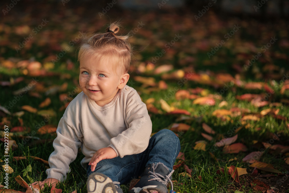 A happy toddler child isolated on the nature background. A happy toddler child isolated on the nature background.