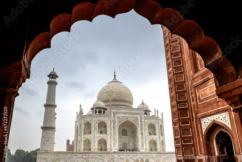 View of the imposing Taj Mahal in Agra, India, with its wonderful architecture on a cloudy day from the side