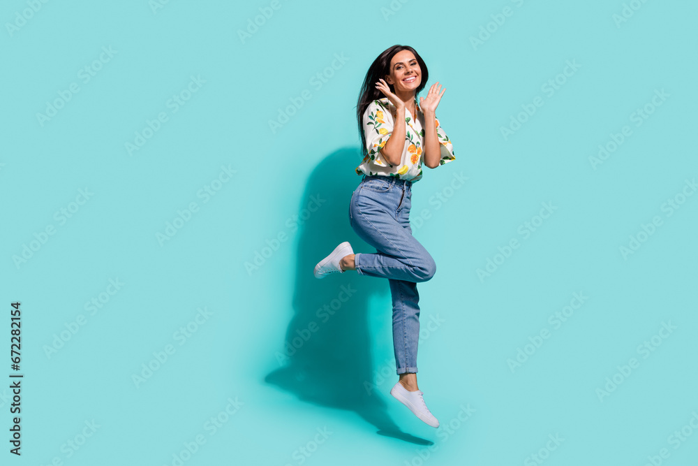 Full length photo of cheerful astonished girl having fun celebrating win lottery jackpot empty space isolated on cyan color background Full length photo of cheerful astonished girl having fun celebrating win lottery jackpot empty space isolated on cyan color background