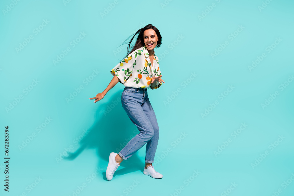 Full size photo of cheerful woman dressed flower print blouse look at discount empty space dancing isolated on turquoise color background