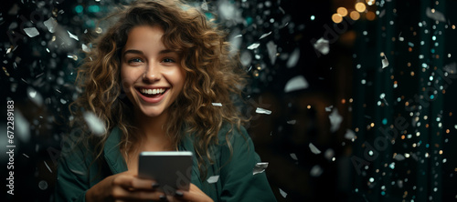 cheerful woman with a large mobile phone, under confetti, rejoices about winning