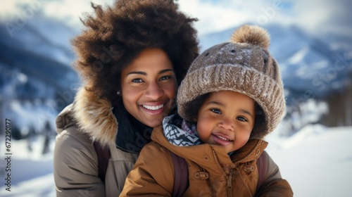 Happy african american mother and daughter in winter clothes.