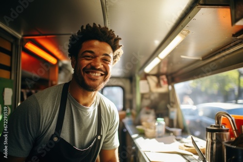Smiling mid adult male owner looking away while standing in food truck photo