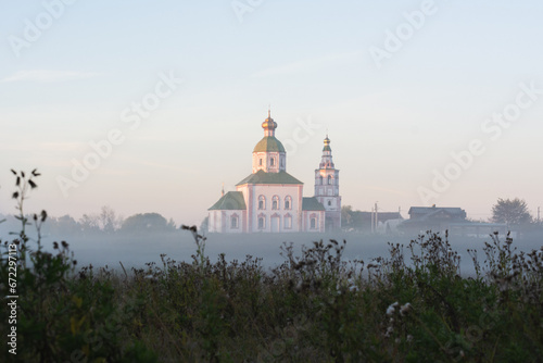 autumn landscape with soft morning light, church at dawn in the fog. Suzdal, Russia