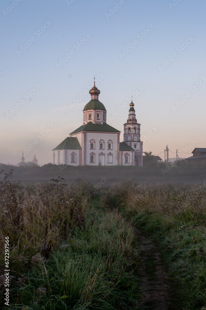 autumn landscape with soft morning light, church at dawn in the fog. Suzdal, Russia