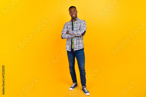 Full size body photo of young successful entrepreneur smiling web developer entrepreneur folded hands isolated on yellow color background