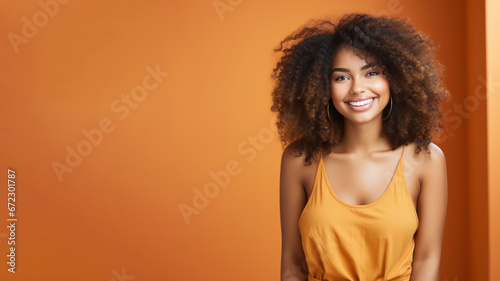 Afro-american woman model wearing a orange sundress isolated on pastel