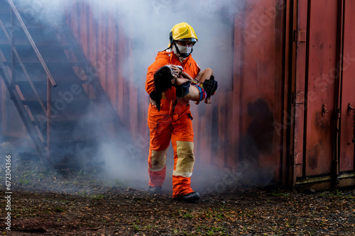 Firefighter to save girl in fire and smoke. Rescue Team or Firefighters save lives people from fire. Firefighter or Emergency team rescue saving life people from fire.