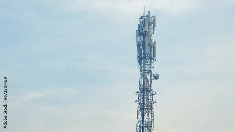 Cell phone signal transmitting towers stand tall with sky in background on a misty morning. Cell phone signal transmitting towers stand tall with sky in background on a misty morning.