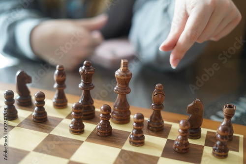 hand playing chess, people playing chess, hands only, hand holding chess pieces