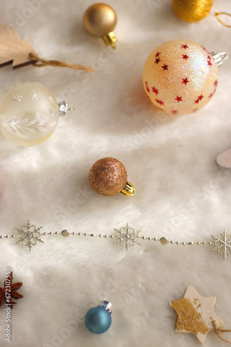 Various colorful Christmas oranments and white faux fur blanket. Selective focus. photo