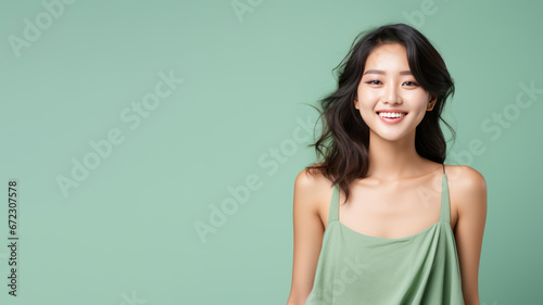Asian woman model wear a green sundress isolated on pastel background