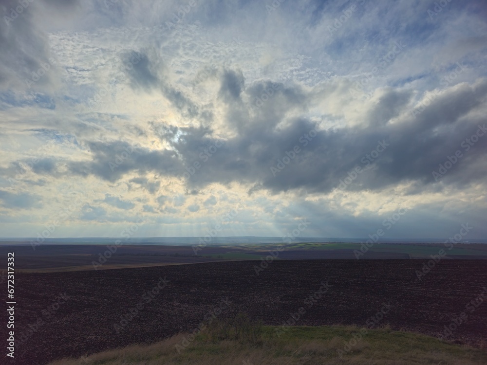 Fototapeta premium A cloudy sky over a field