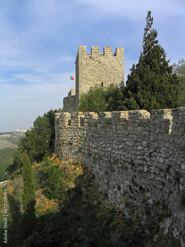 Medieval Sesimbra castle, Portugal. View of the defensive wall and watchtower overlooking the landscape