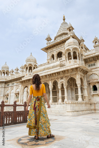 Woman in yellow looks at the Jaswant Thada palace in Jodhpur in Rajasthan, India. The blue city © angel