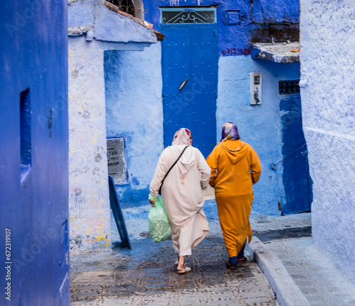 women walking on the blue streets of Chefchaouen Morocco © Agata Kadar