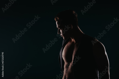 A silhouette of a fit athlete flexing muscles  inspiring with body transformation results and motivating others.