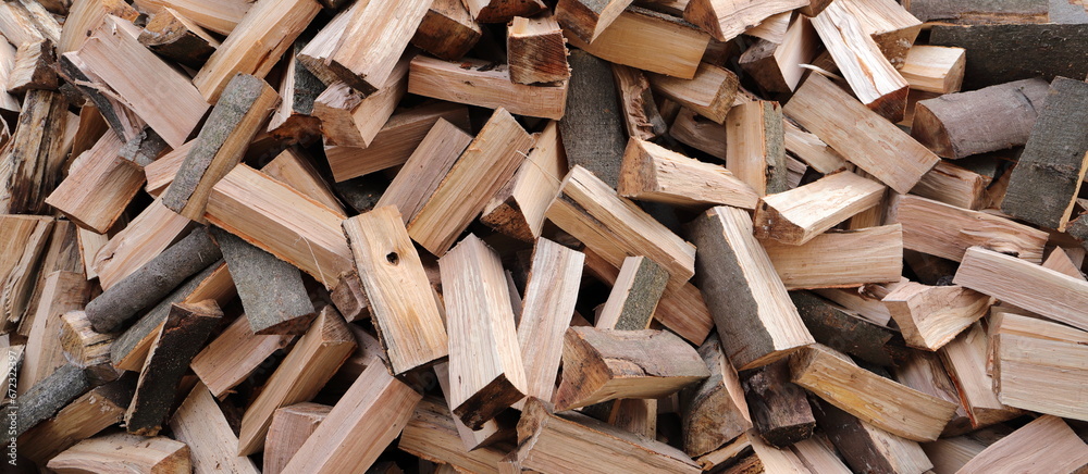stacked dry firewood as a background - obrazy, fototapety, plakaty 