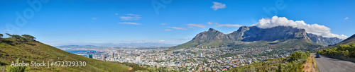 Mountain landscape and panorama view of coastal city, residential buildings or infrastructure in famous travel or tourism destination. Copy space and scenic blue sky of Table Mountain in South Africa © Dhoxax/peopleimages.com
