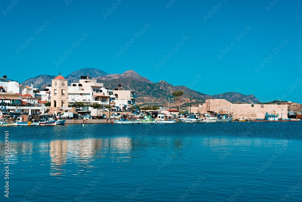 Picturesque harbor, with several boats moored in the water in Ierapetra, Crete, Greece