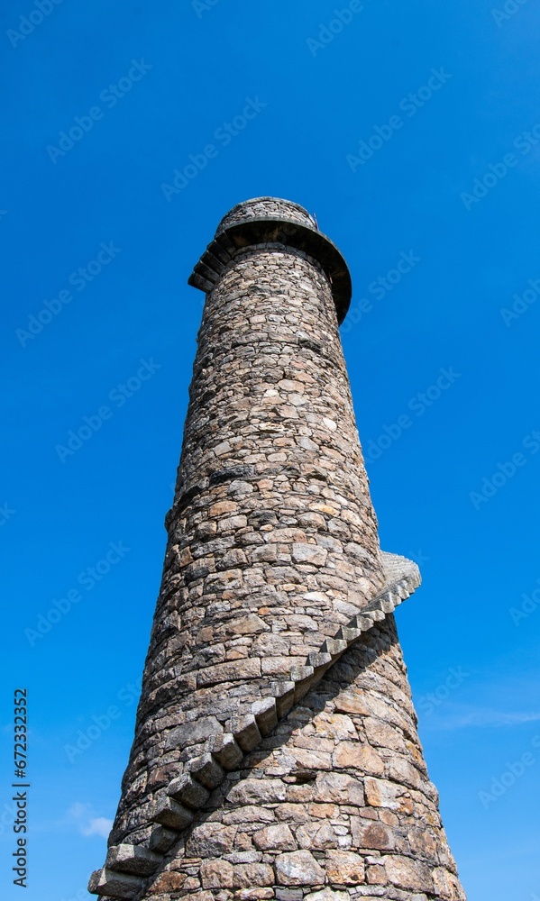 Low-angle shot of Ballycorus Flue Chimney against the background of a blue sky. Dublin, Ireland.